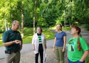 Forest advocates have a skeptical dialogue with DNR staff at a timber sale protest at Owen-Putnam State Forest in June 2018.