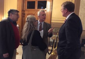 IFA Director Jeff Stant, biologist Leslie Bishop, and economist Morton Marcus make the case in the statehouse halls to a representative for leaving some forest unlogged.